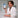 Woman in a white robe holding a supplement container labeled 'Hair, Skin & Nails' in a kitchen setting.
